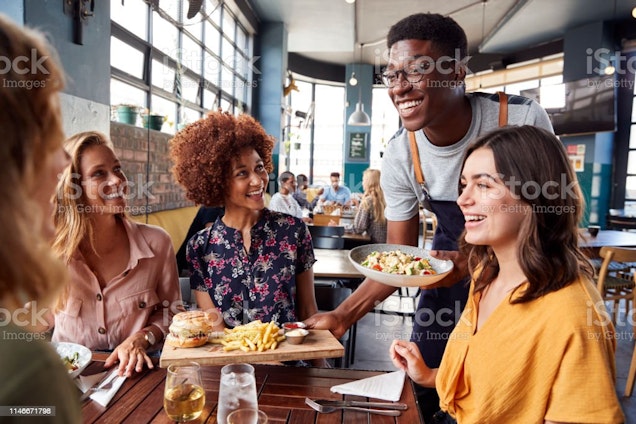 man serving guests